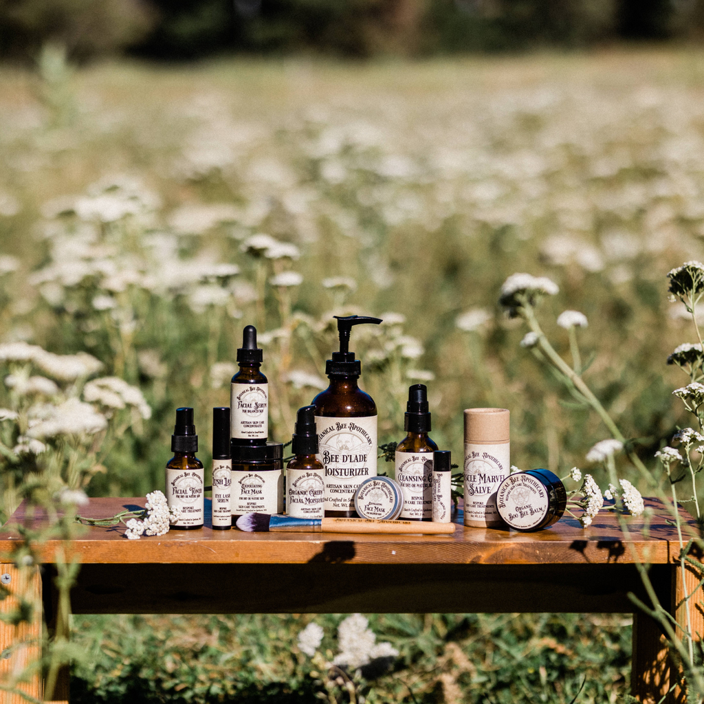 Botanical Bee Apothecary's all natural artisan skincare concentrate collection in a Yarrow field on our farm on a sunny day.